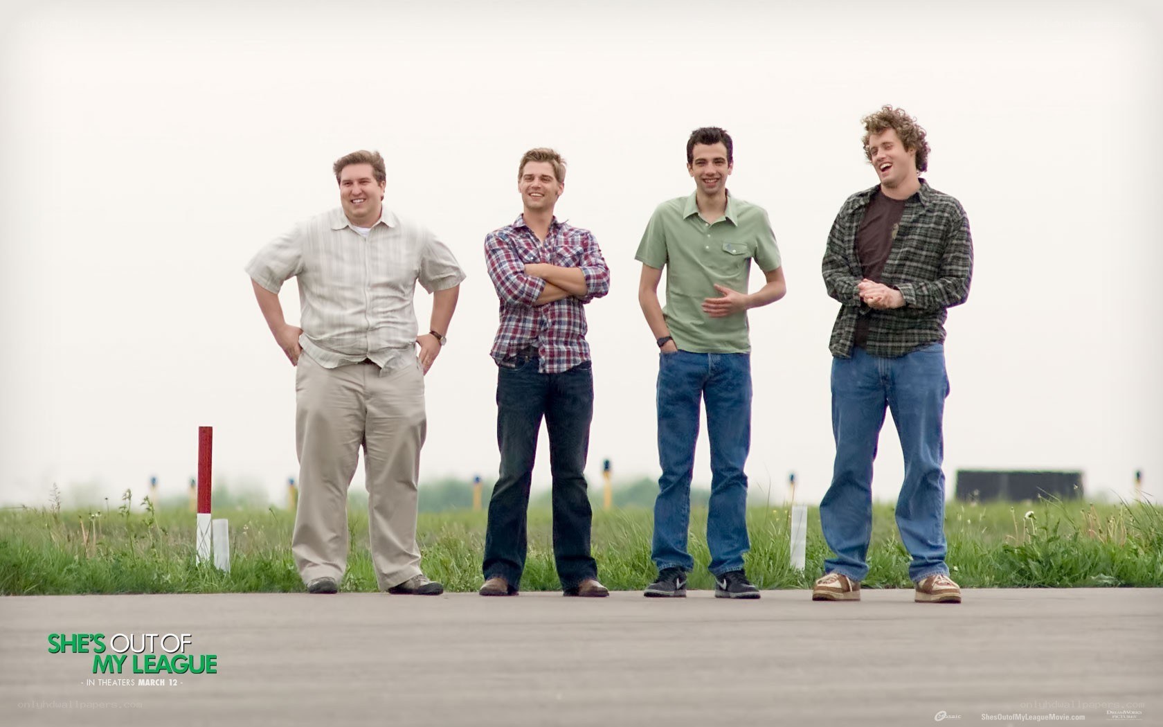 four men standing on a field