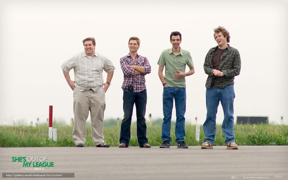 four men standing on runway