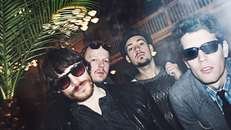 Four Men Wearing Sunglasses
