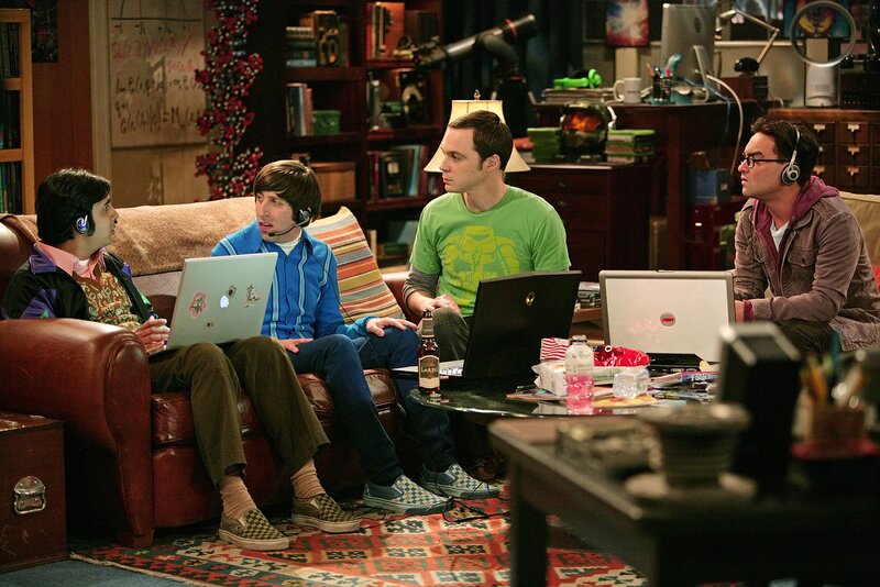 Four men with laptops in a living room
