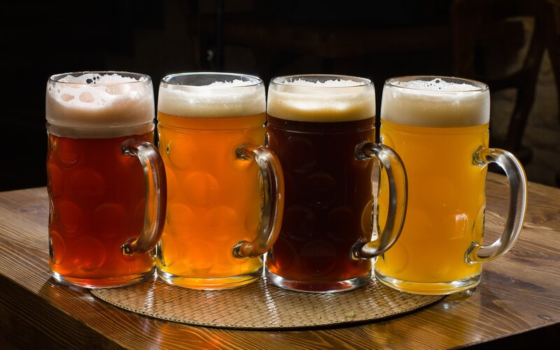 Four mugs of beer on a table