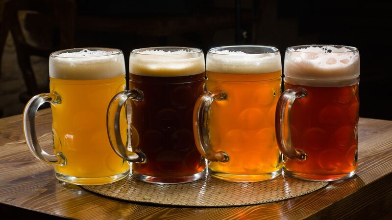 Four mugs of beer on table