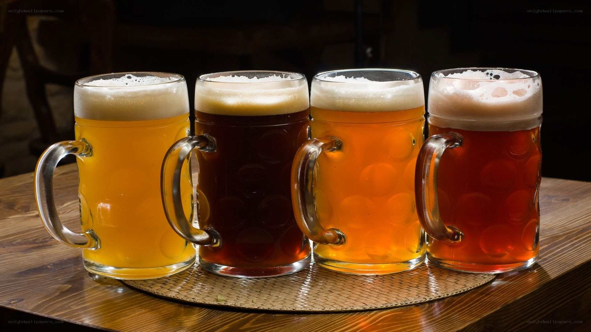 Four mugs of beer on table