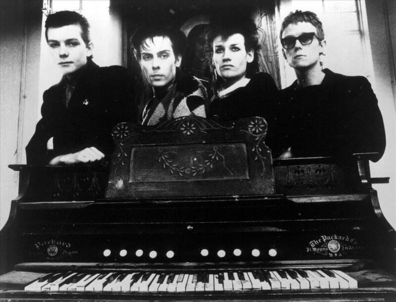 Four People Behind Piano — Black