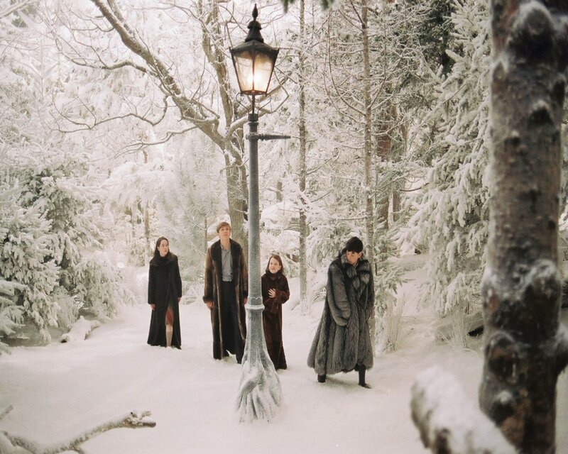 Four people in a snowy forest
