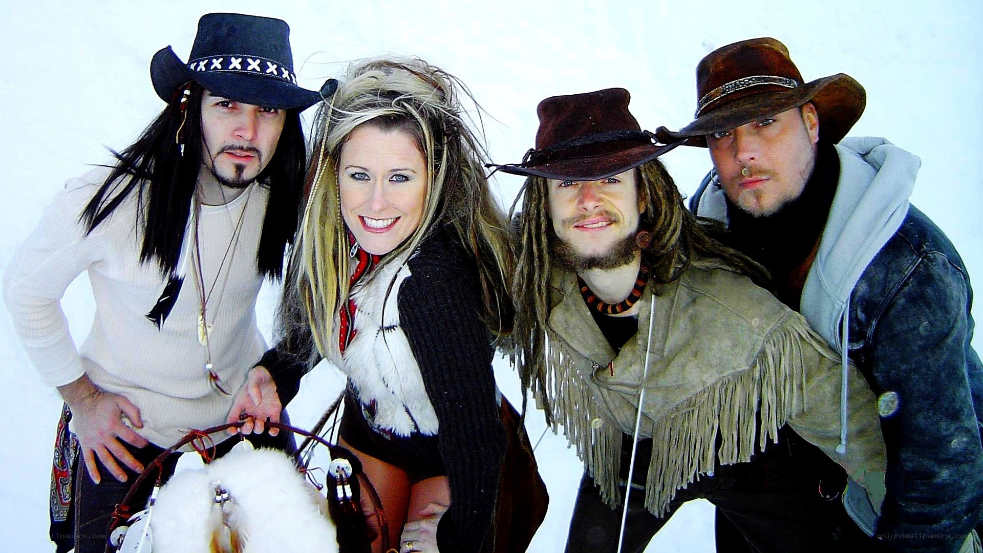 Four people in cowboy hats in snow