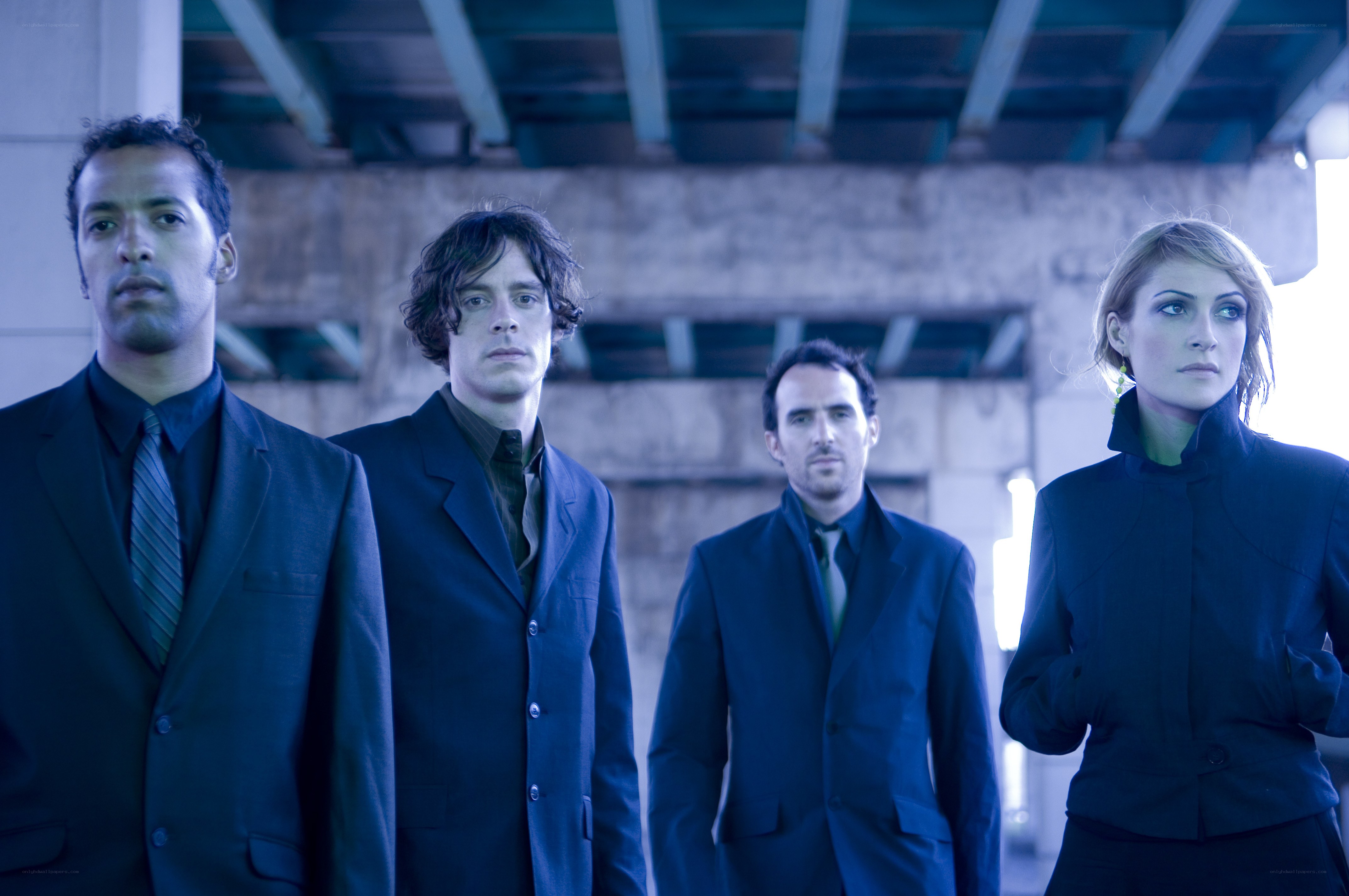 four people in dark suits