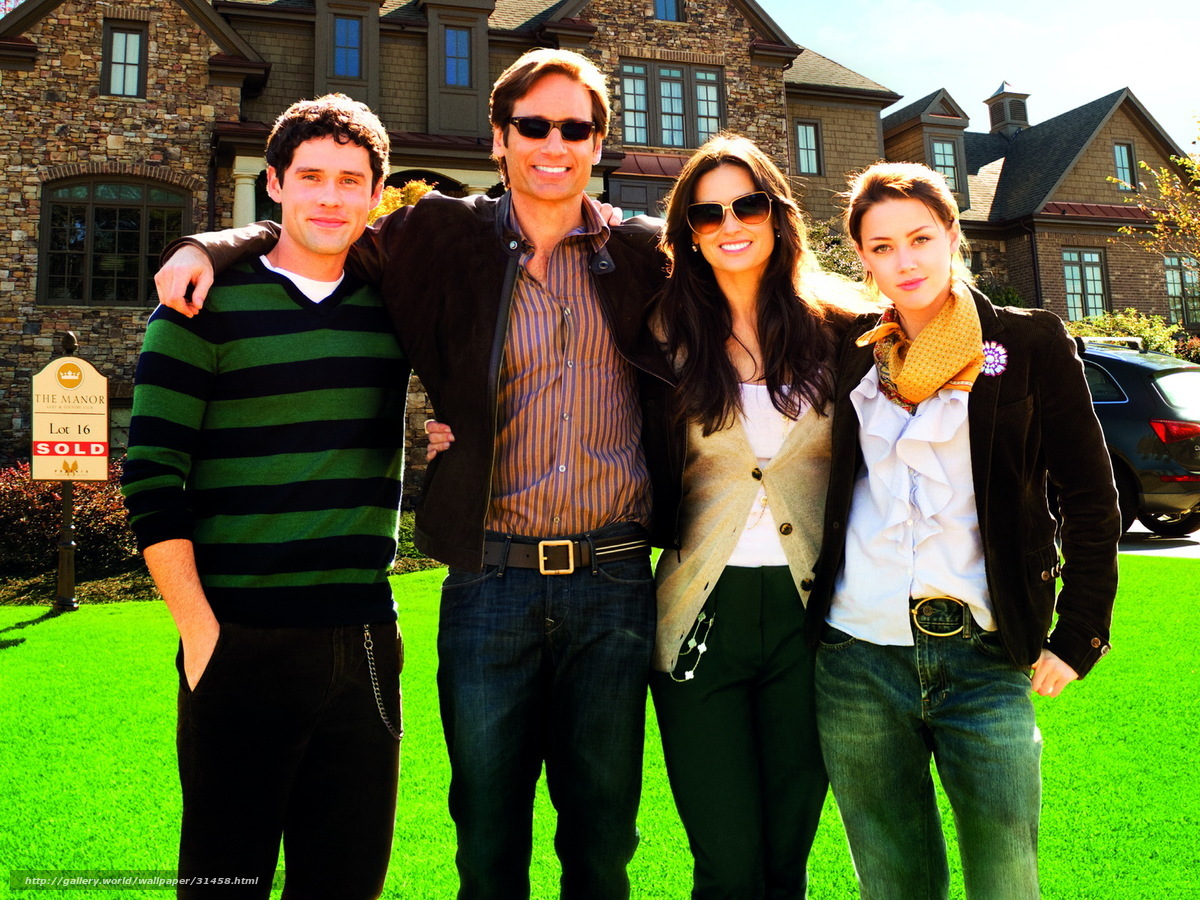 Four people in front of a mansion