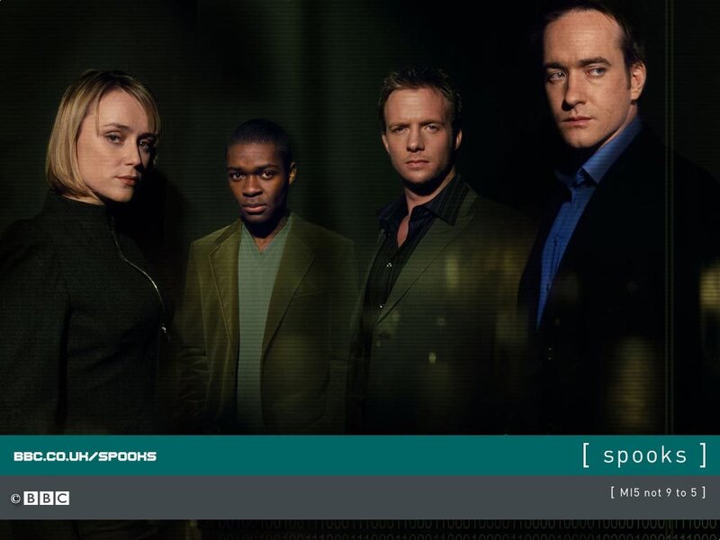 Four People in Suits — Black, Serious