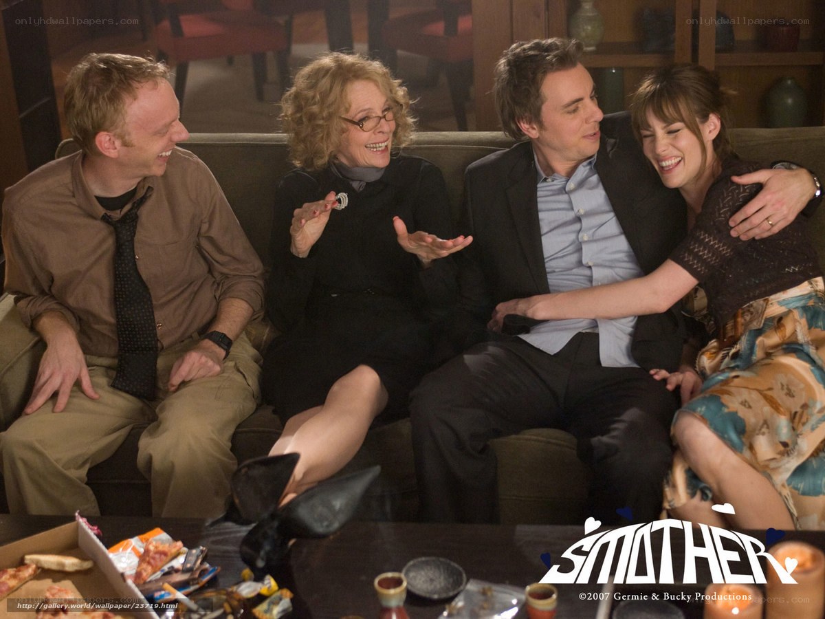 Four people laughing on a couch