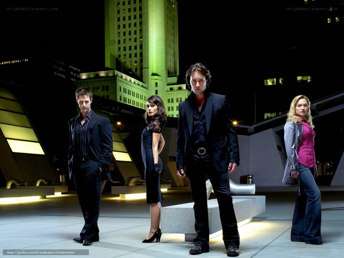 Four people on a rooftop at night