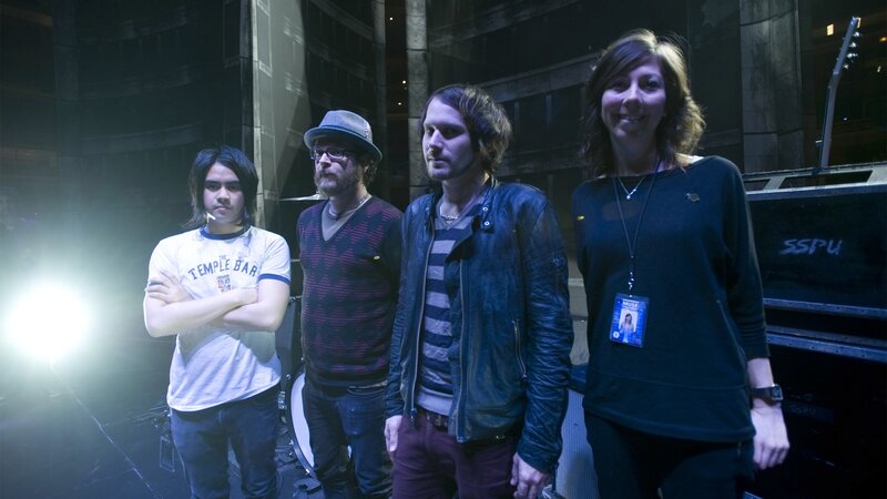Four People on Stage — Black