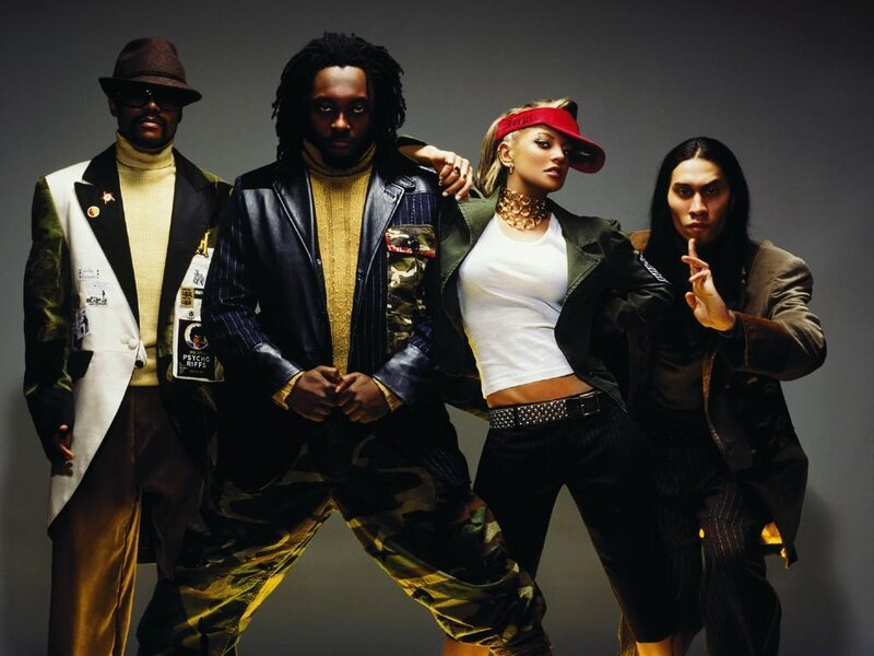 Four people posing in stylish outfits