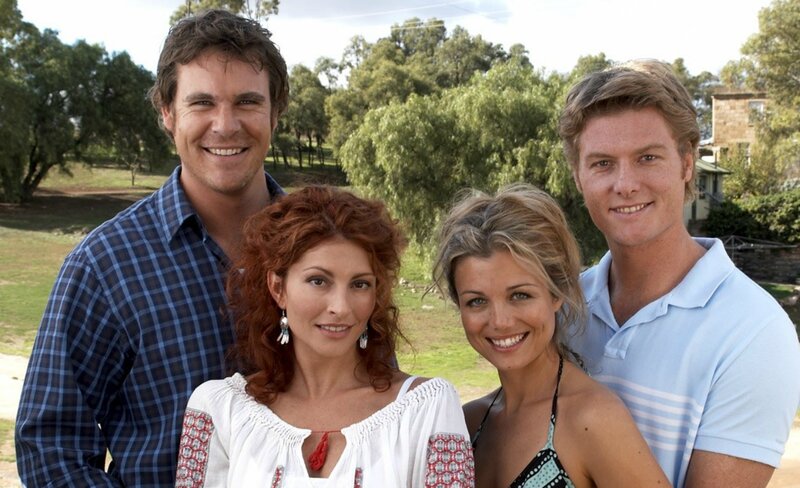 Four People Posing Outdoors