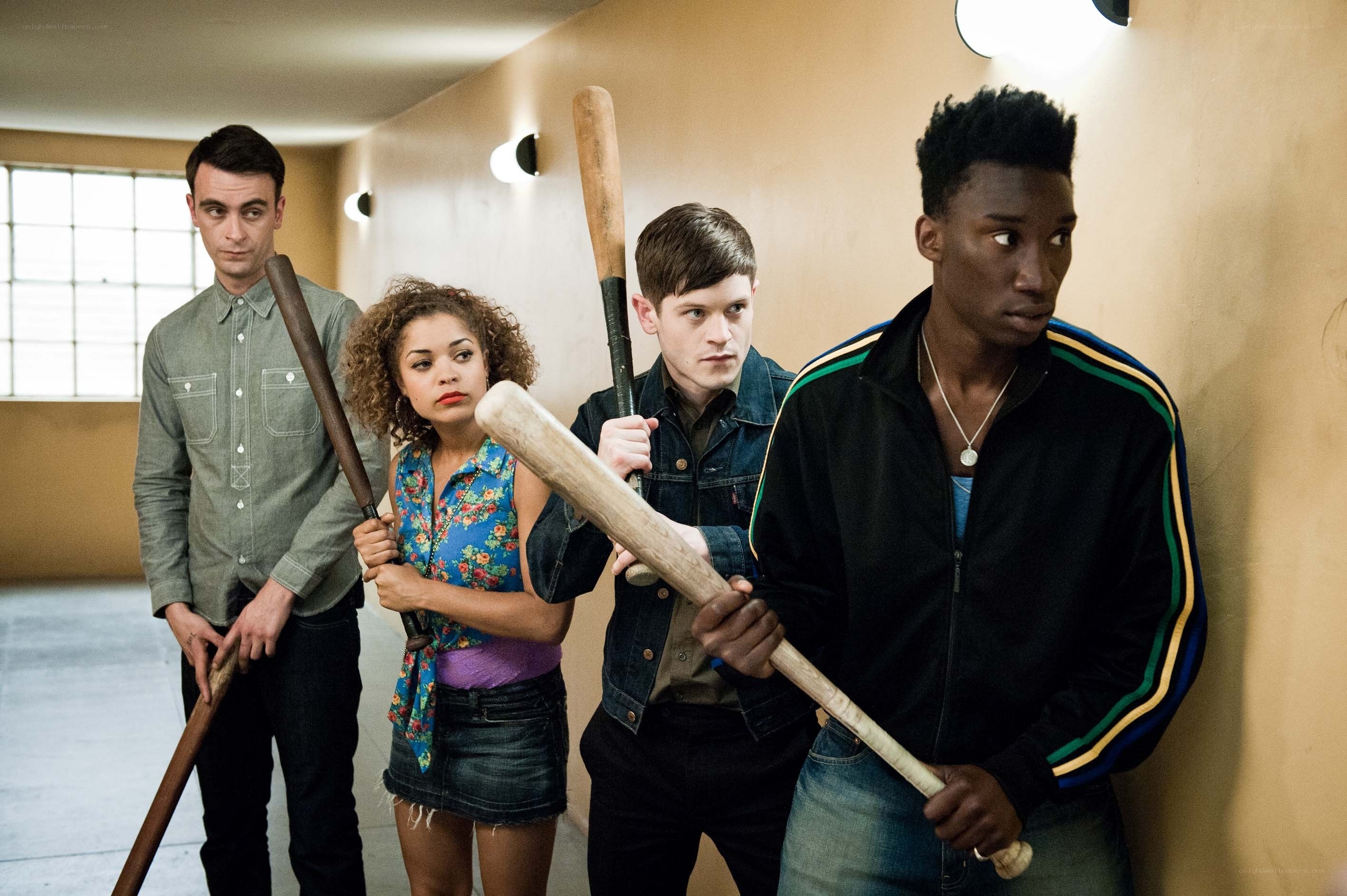 four people with baseball bats