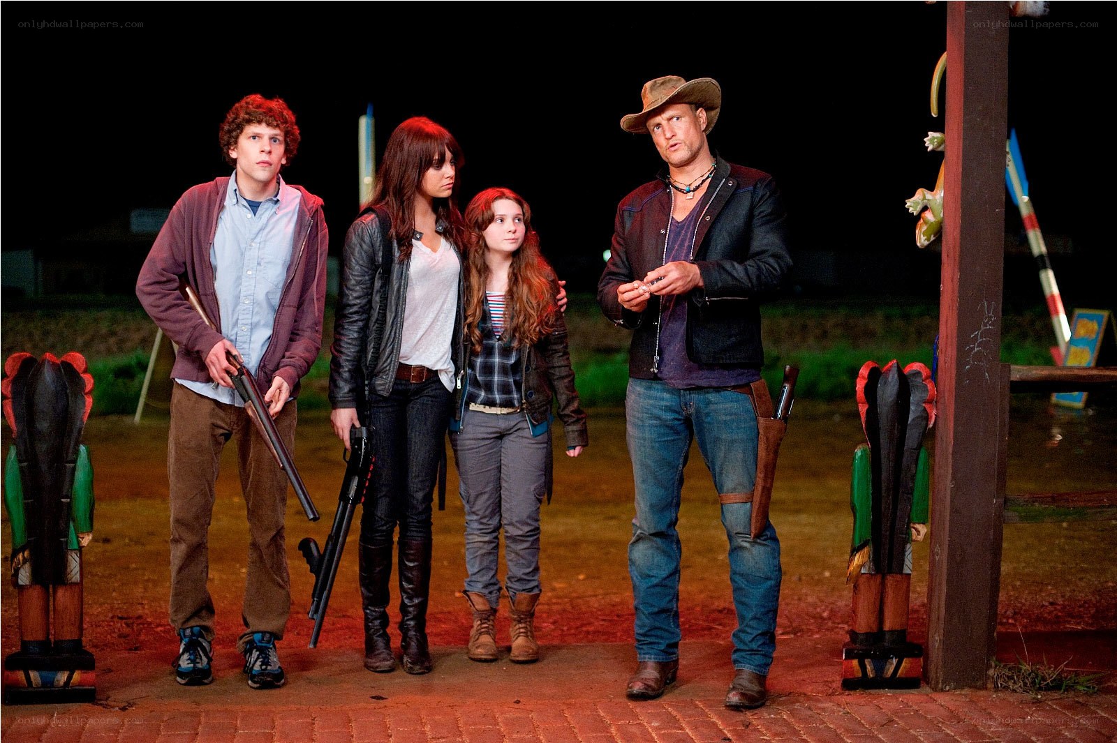 Four people with guns at night