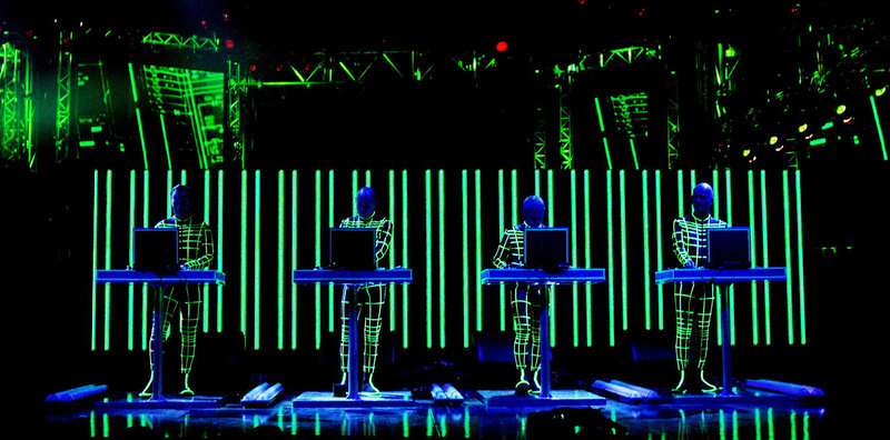Four performers on stage with laptops