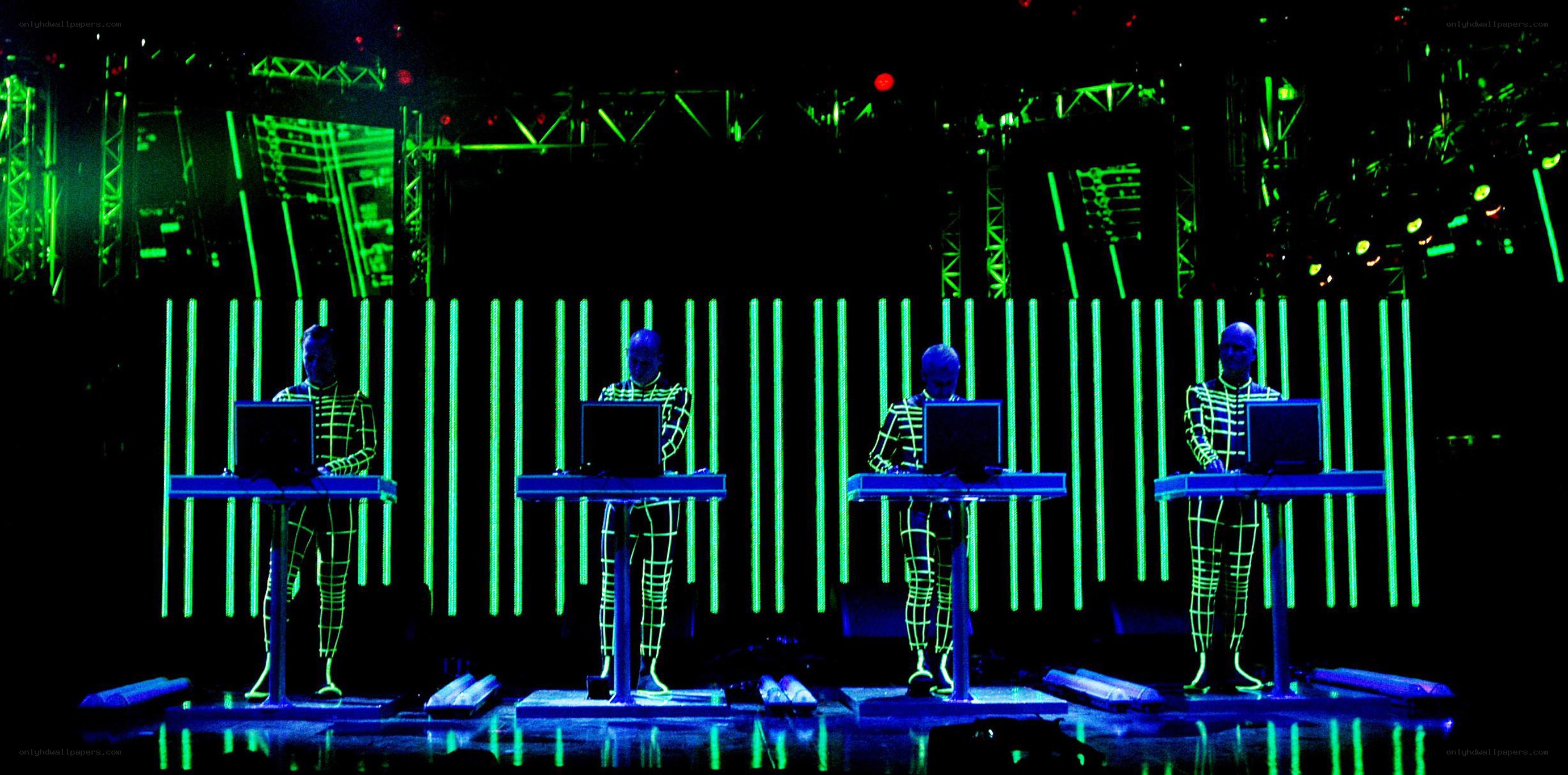 Four performers on stage with laptops