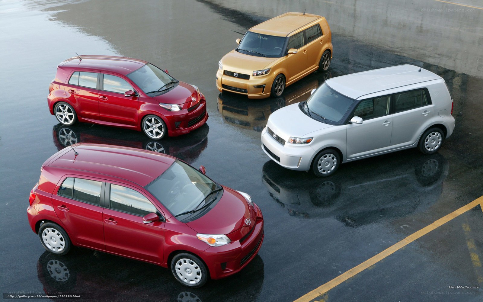 Four Scion xB cars on wet pavement