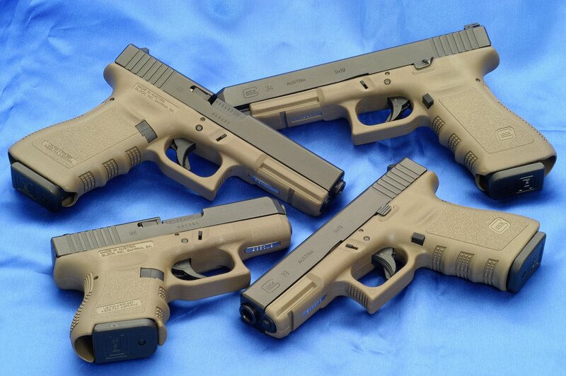 Four Tan Handguns