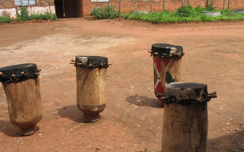 Four traditional drums on dirt ground