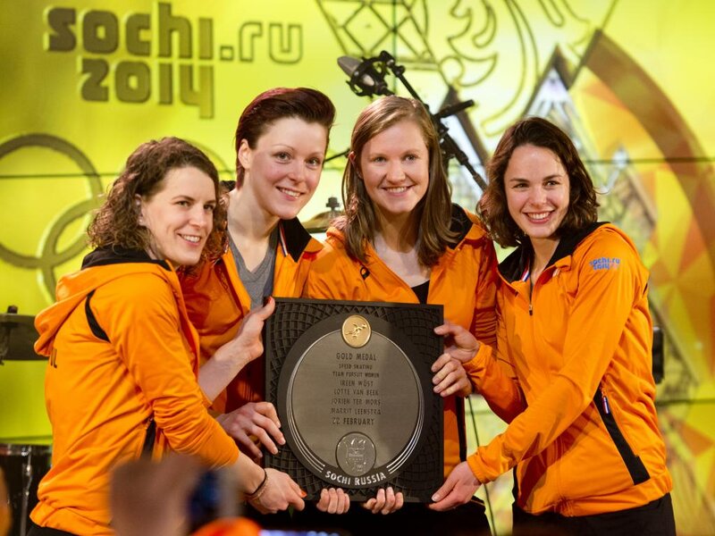 Four Women Holding Plaque