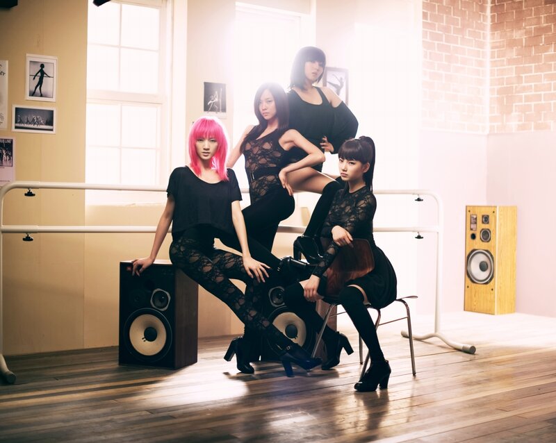 four women in black outfits