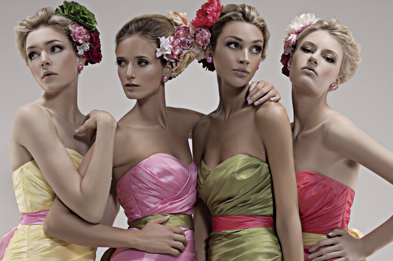four women in colorful dresses