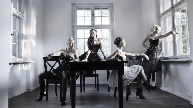 four women in elegant attire