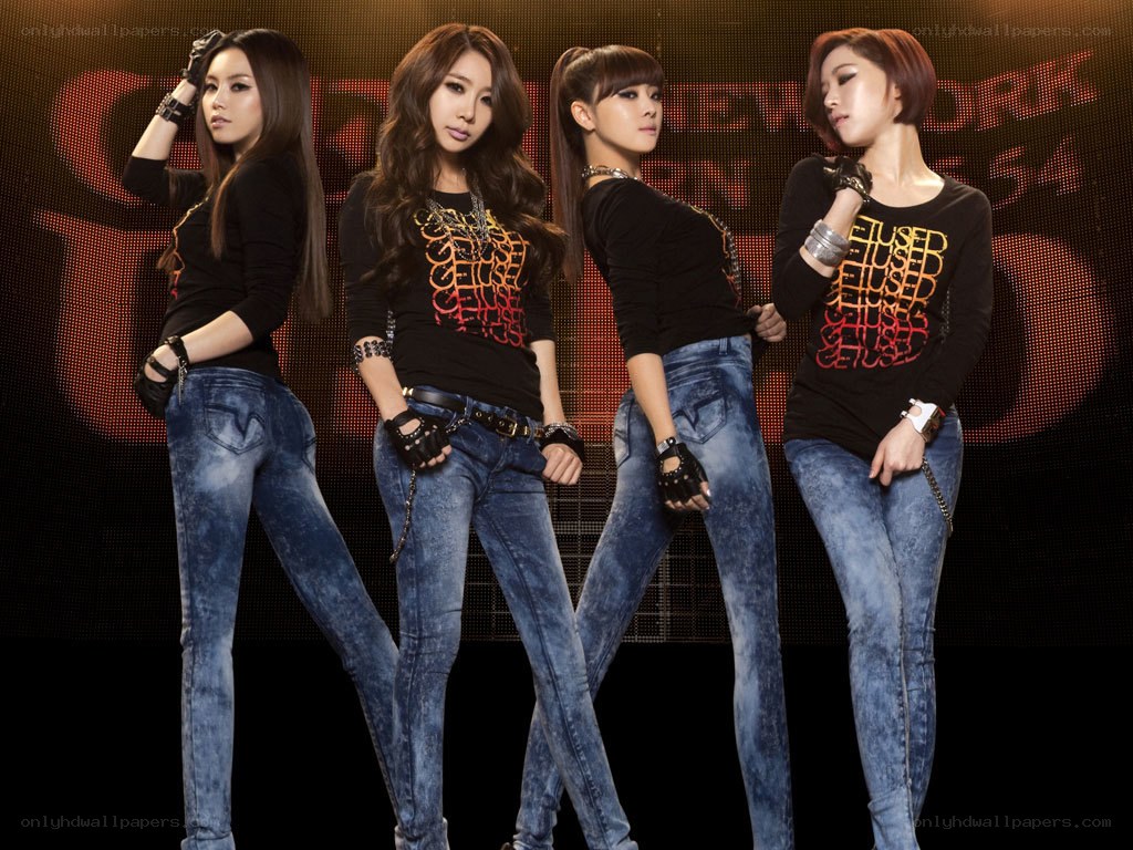 four women in jeans posing