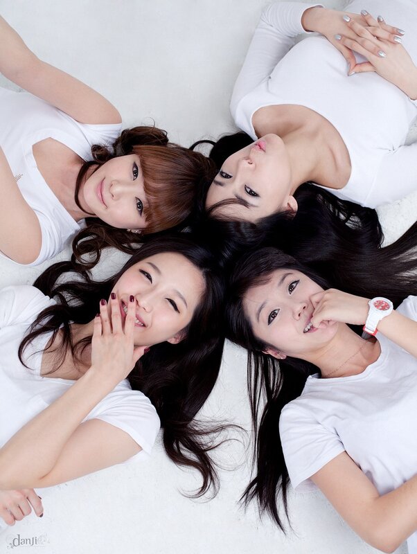 Four women in white shirts lying down