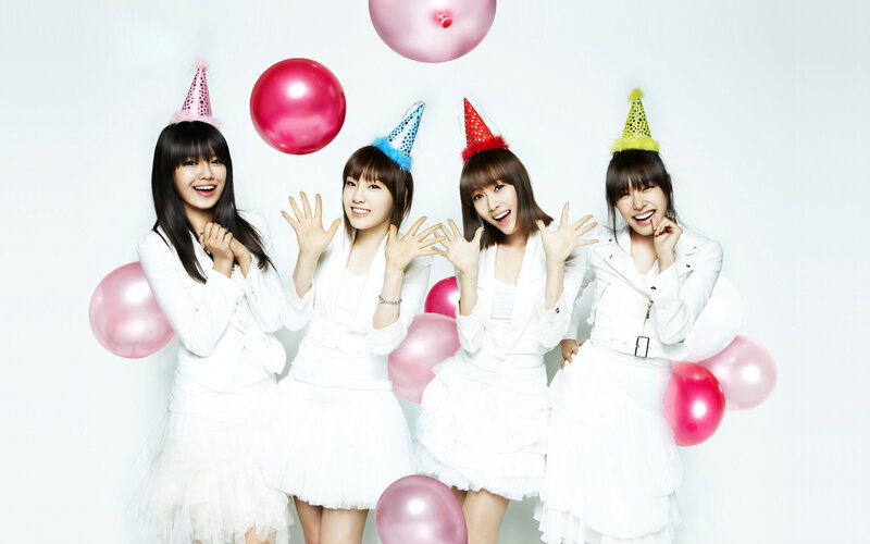 four women in white with party hats