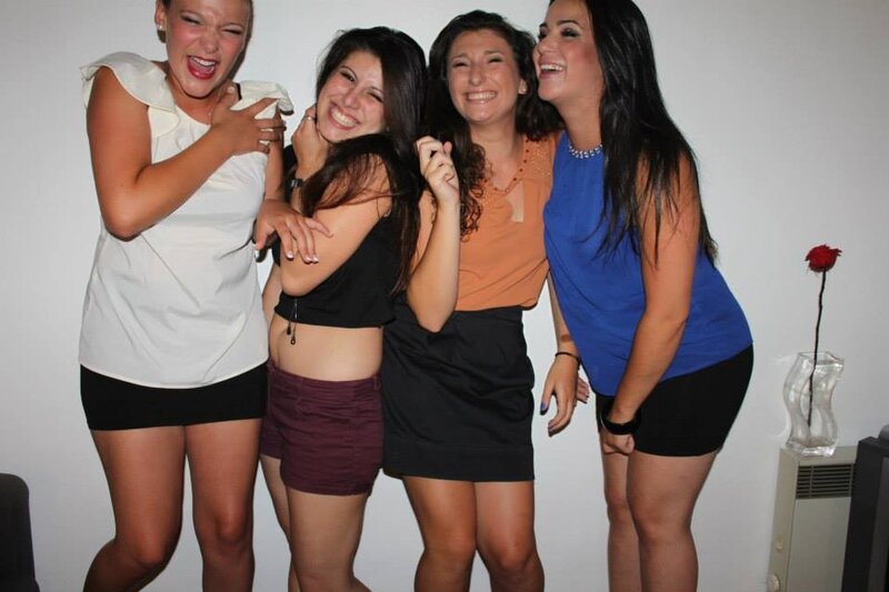 four women laughing together