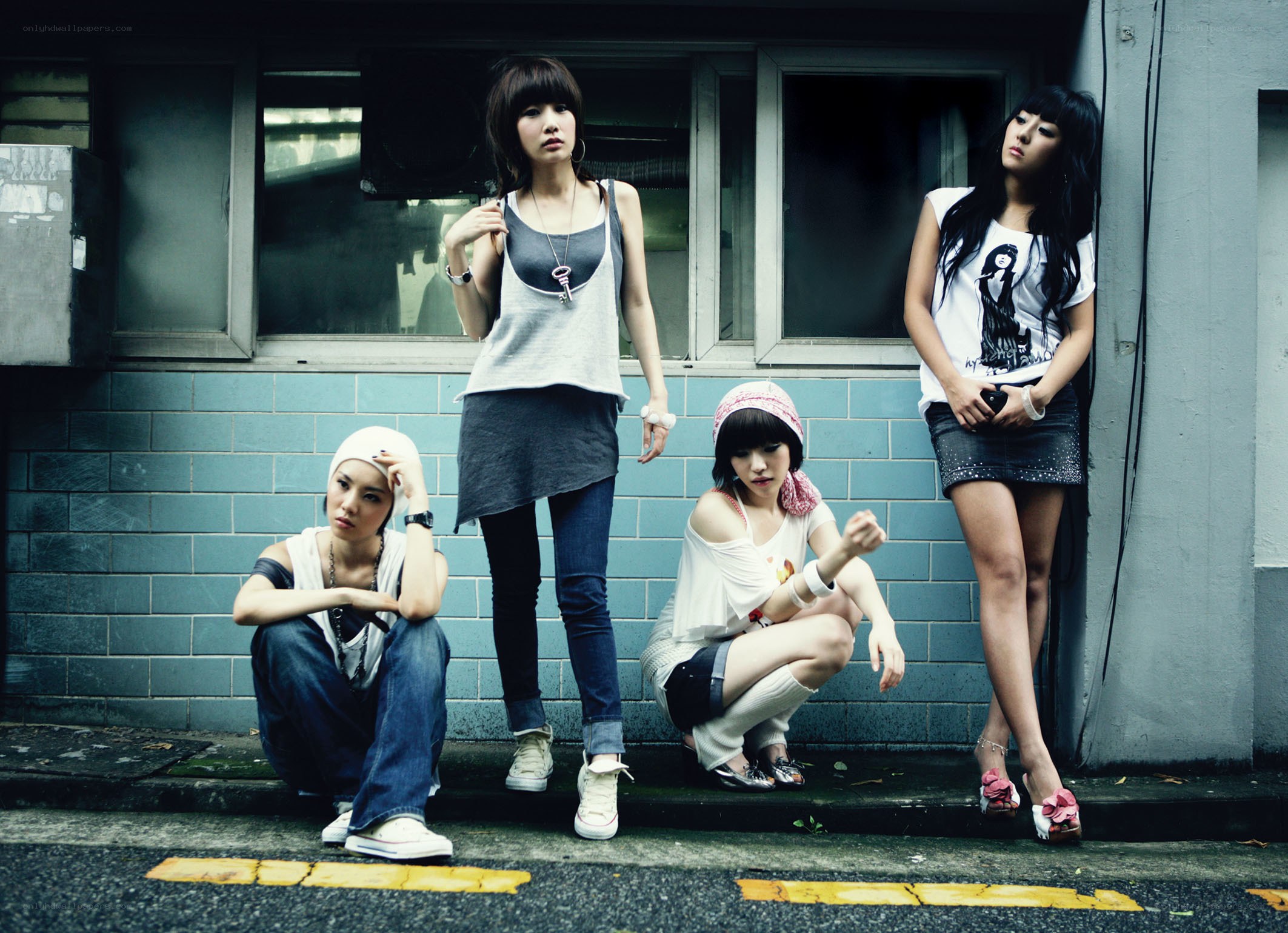 four women posing on street