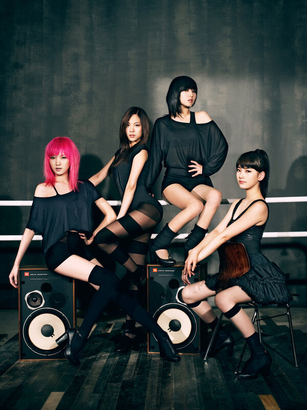 four women posing with speakers