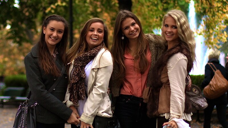 four women smiling in park