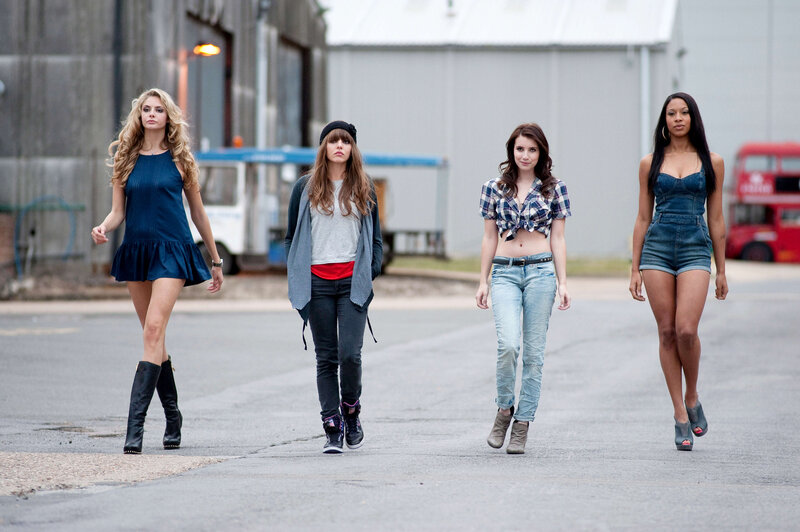 four women walking on street