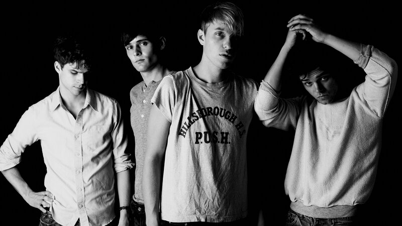 four young men in black and white