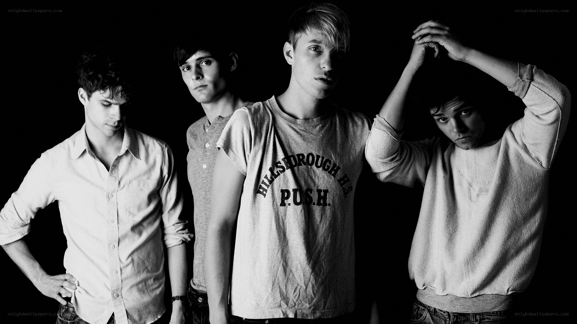 four young men in black and white