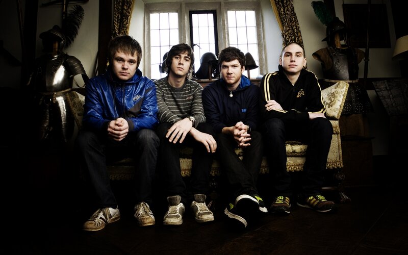 four young men on a couch