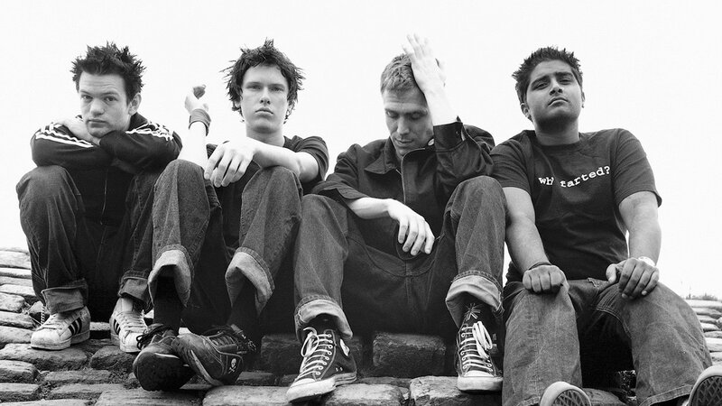 four young men sitting on steps