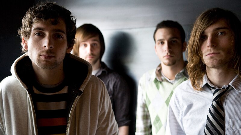 Four Young Men Standing — Gray, Serious