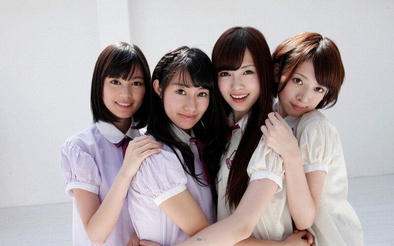 four young women in school uniforms