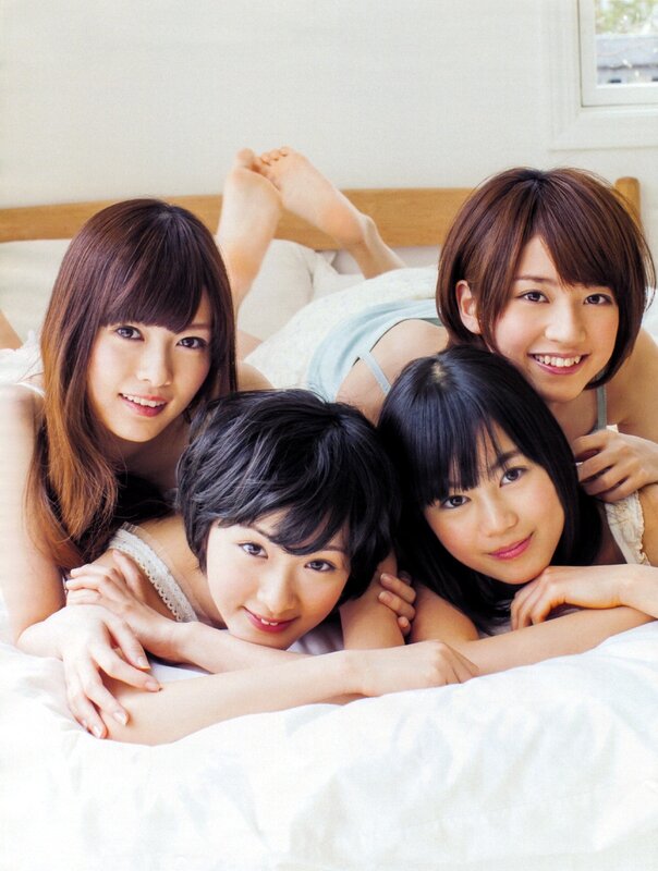 four young women on a bed