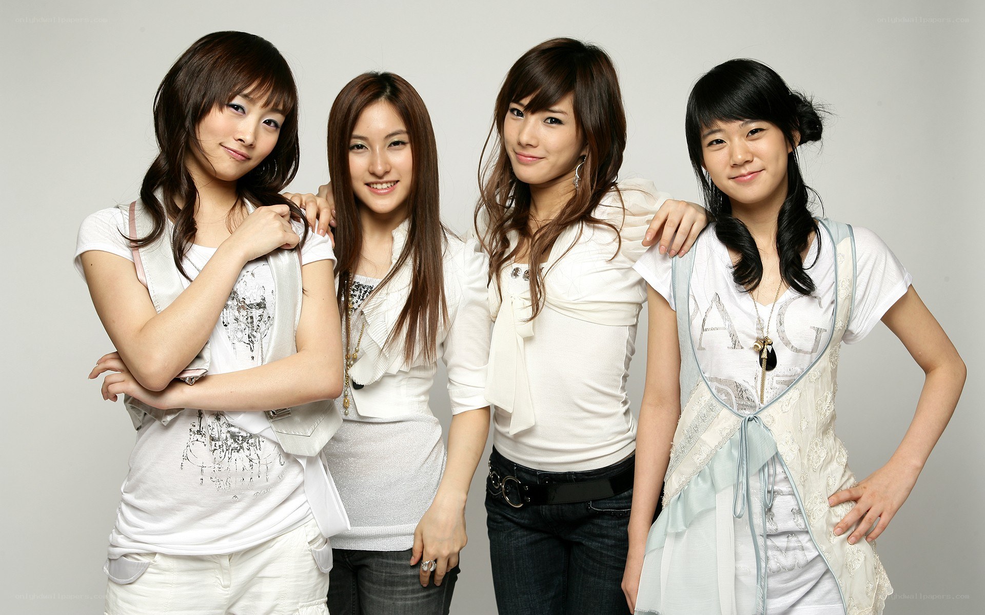 four young women posing together