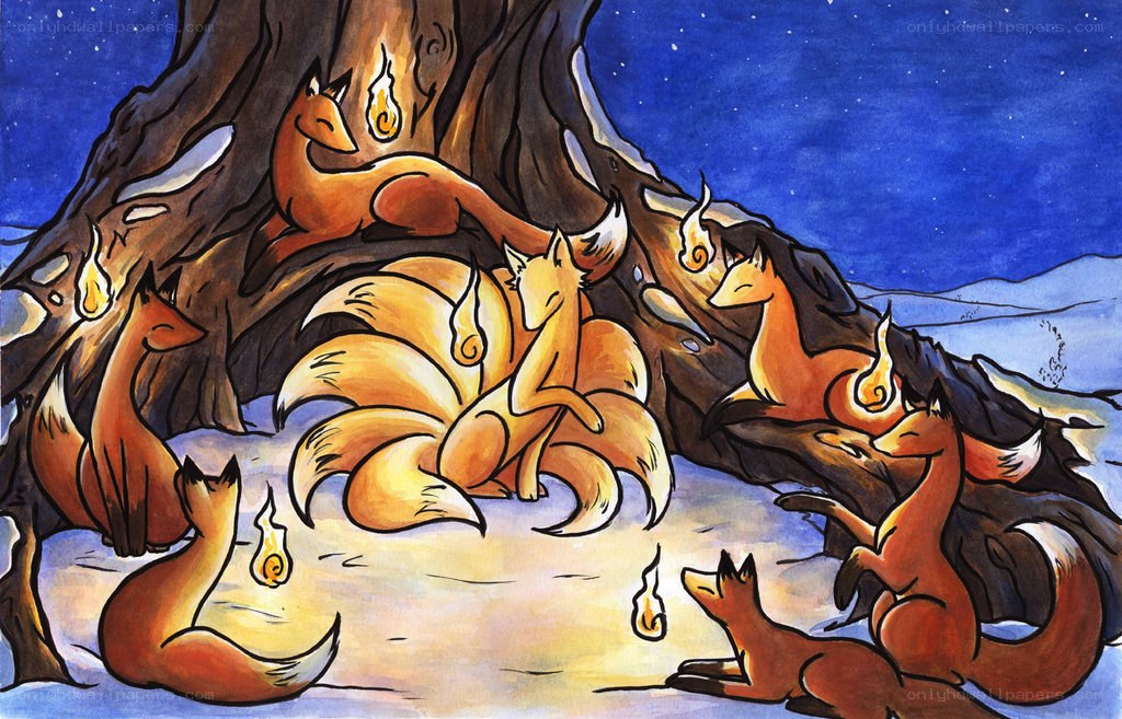 Foxes around a tree at night