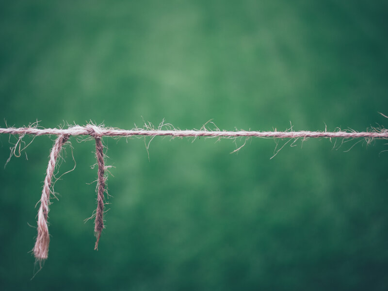 frayed rope against green background