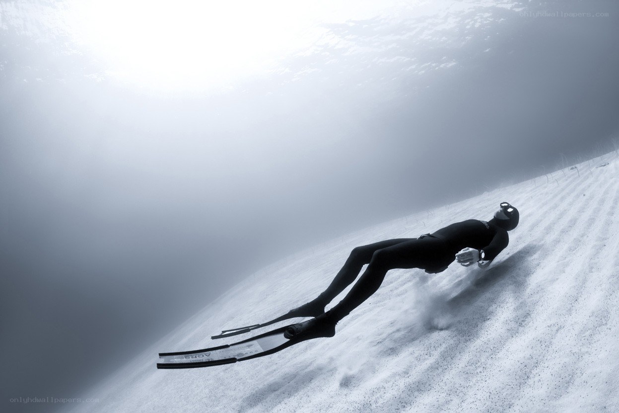 free diver gliding underwater