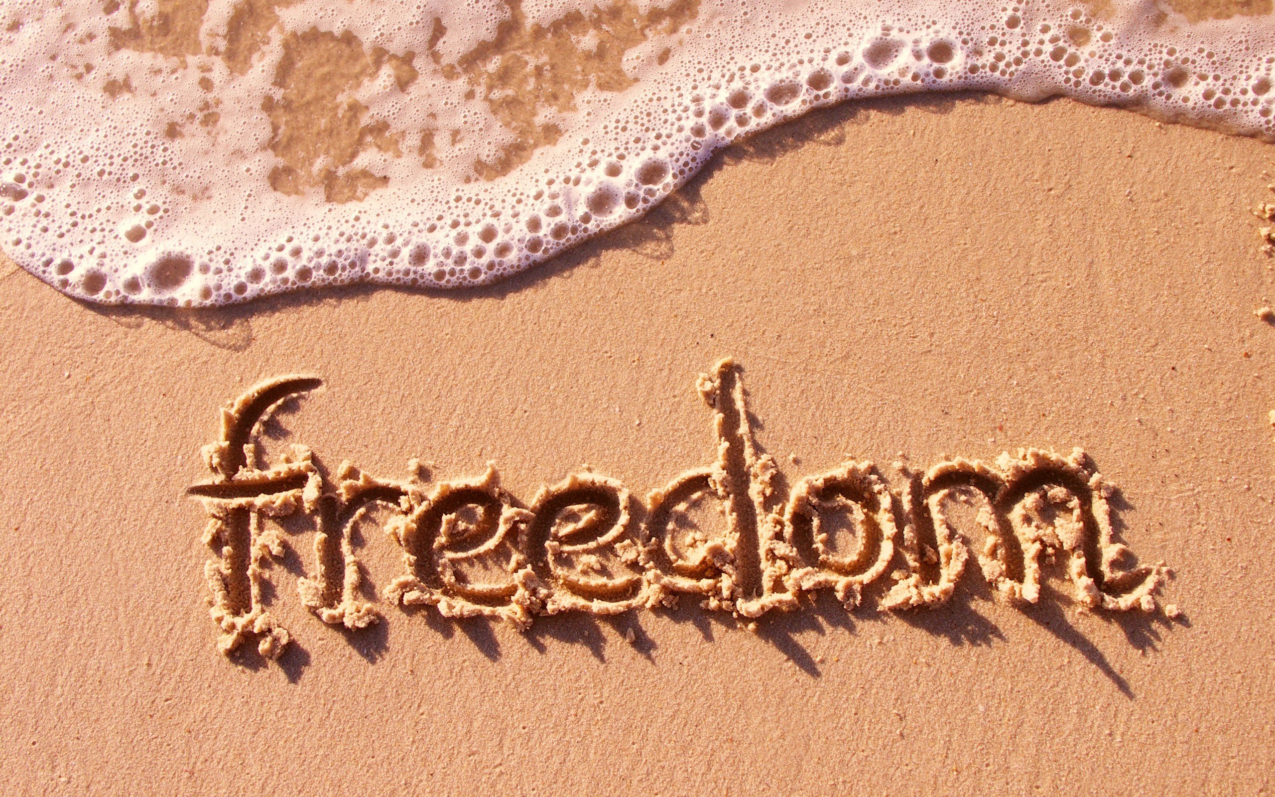 freedom written in sand