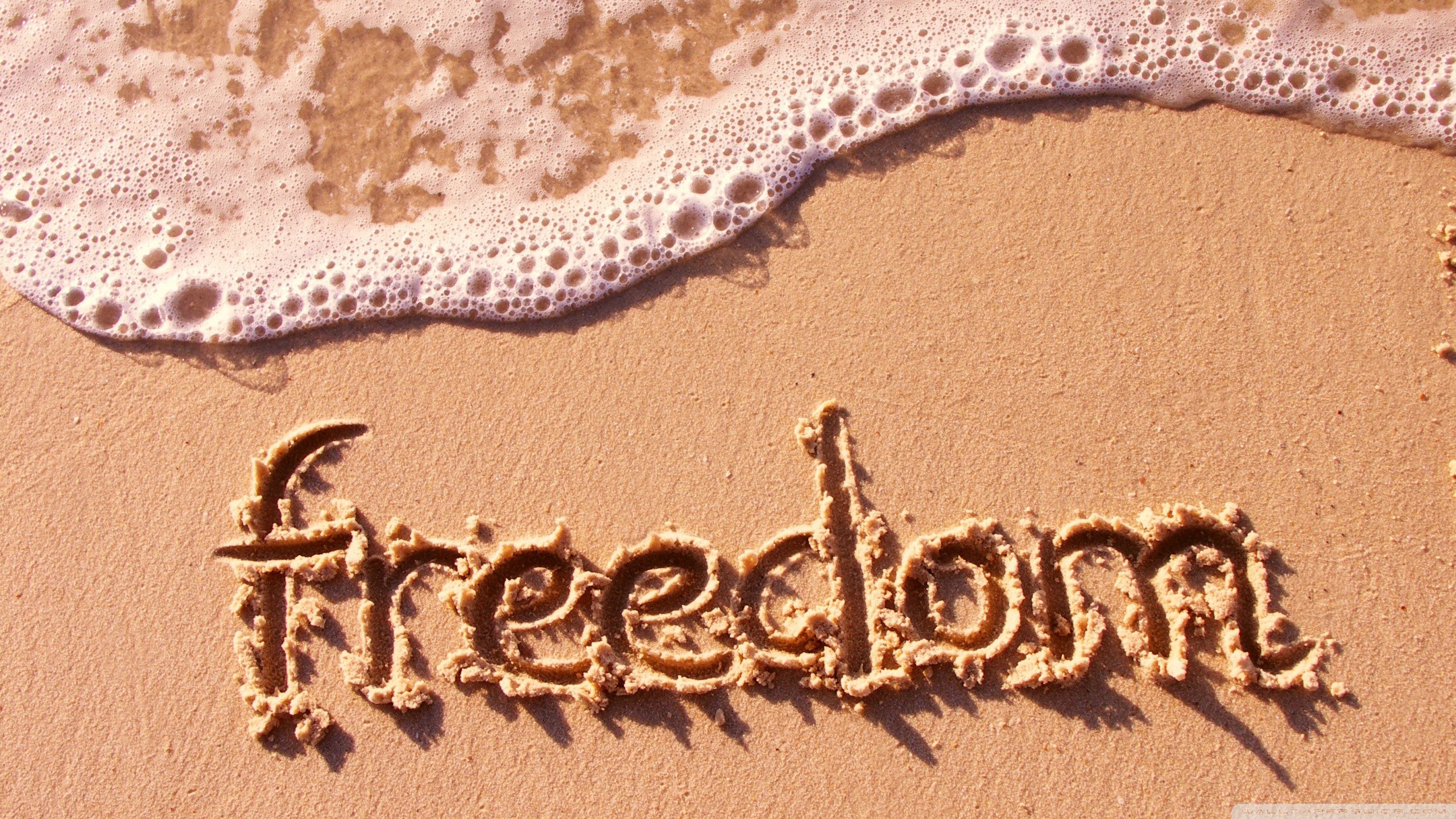 freedom written in sand